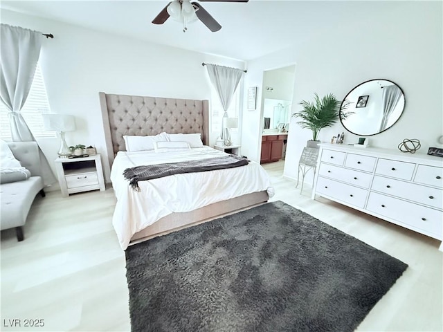 bedroom with ceiling fan, ensuite bath, and light hardwood / wood-style flooring