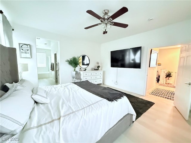 bedroom featuring ceiling fan, light wood-type flooring, and ensuite bath