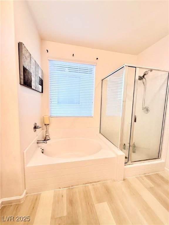 bathroom with separate shower and tub and hardwood / wood-style flooring