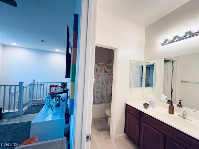 full bathroom featuring bathing tub / shower combination, vanity, and toilet