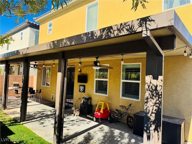 back of property with a patio and ceiling fan