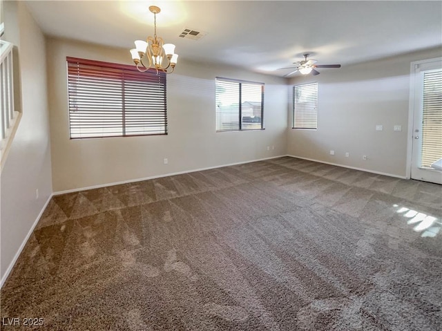 spare room with carpet and ceiling fan with notable chandelier