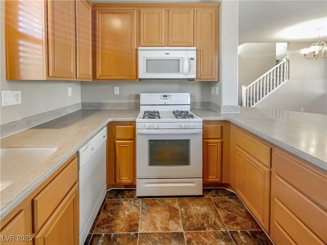 kitchen with white appliances and a chandelier