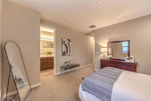 bedroom featuring light colored carpet and connected bathroom