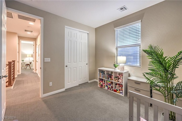 bedroom with a closet and light colored carpet