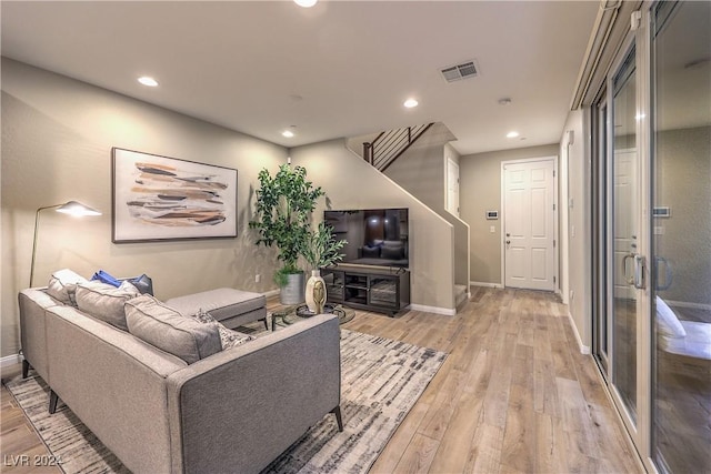 living room with light hardwood / wood-style flooring