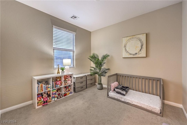 bedroom with light colored carpet and a crib