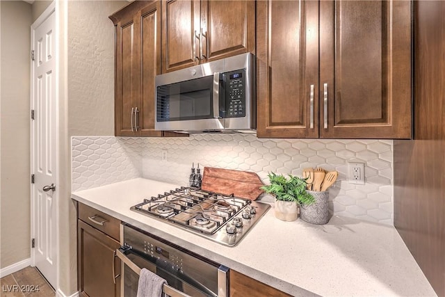 kitchen featuring appliances with stainless steel finishes and tasteful backsplash