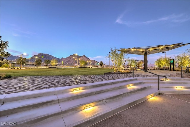 view of property's community with a mountain view and a yard