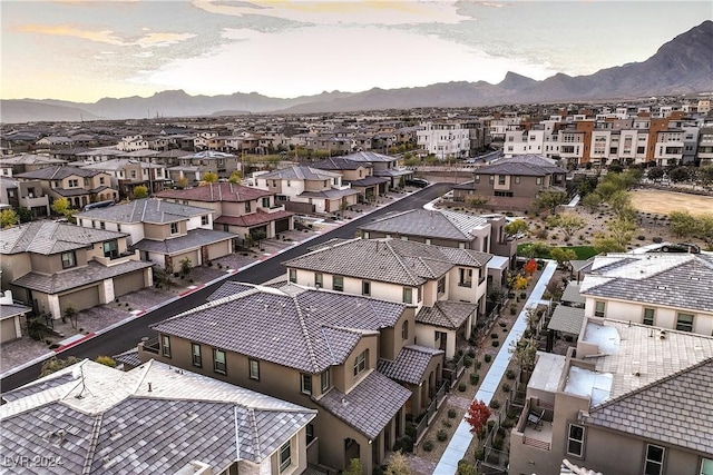 aerial view at dusk featuring a mountain view