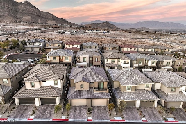 aerial view at dusk featuring a mountain view