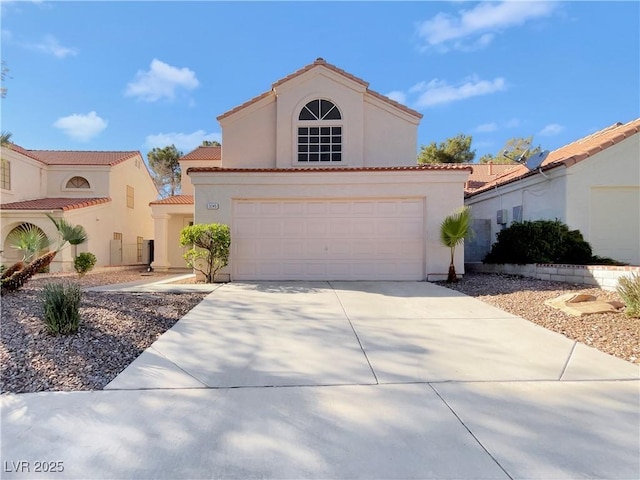 mediterranean / spanish-style home with a garage