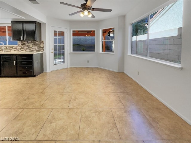 interior space with plenty of natural light, ceiling fan, and light tile patterned floors