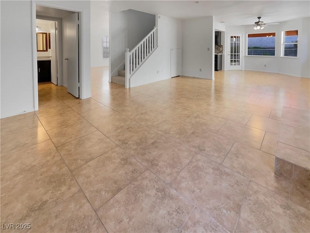 unfurnished living room with ceiling fan and light tile patterned floors