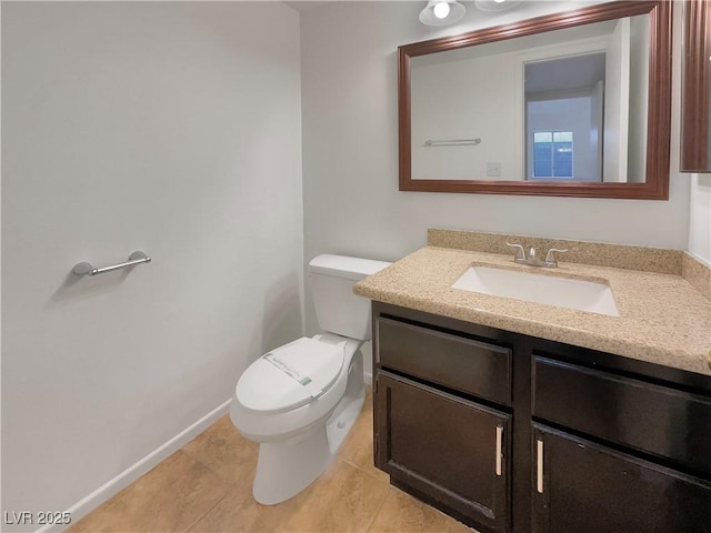 bathroom featuring tile patterned flooring, vanity, and toilet