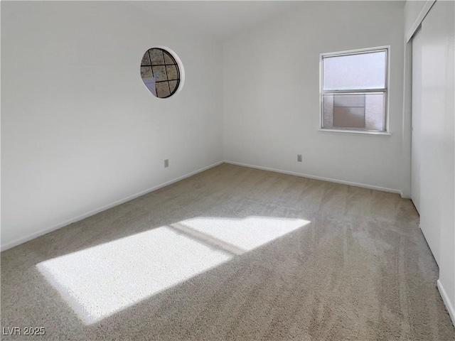 unfurnished room featuring light colored carpet