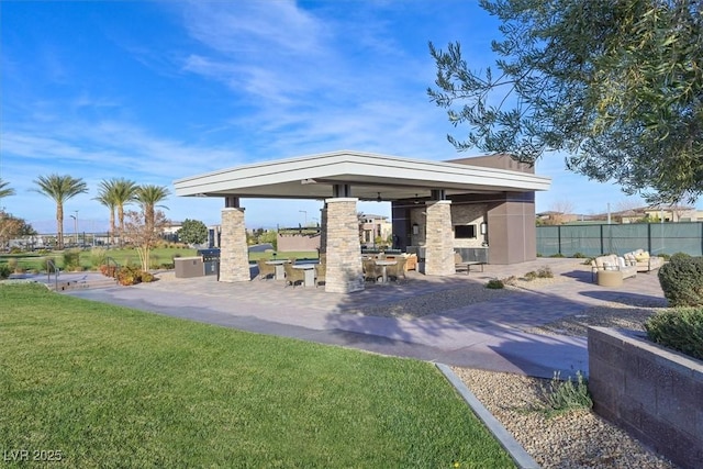 exterior space with a gazebo, a fireplace, and exterior kitchen