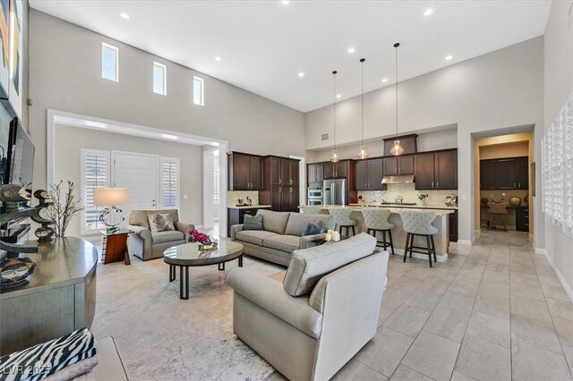 tiled living room with a high ceiling