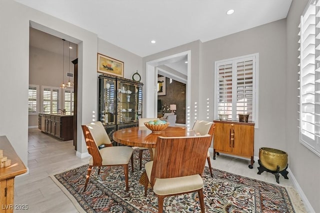 dining space featuring light hardwood / wood-style flooring and an inviting chandelier