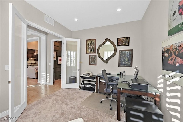 office with light colored carpet and french doors