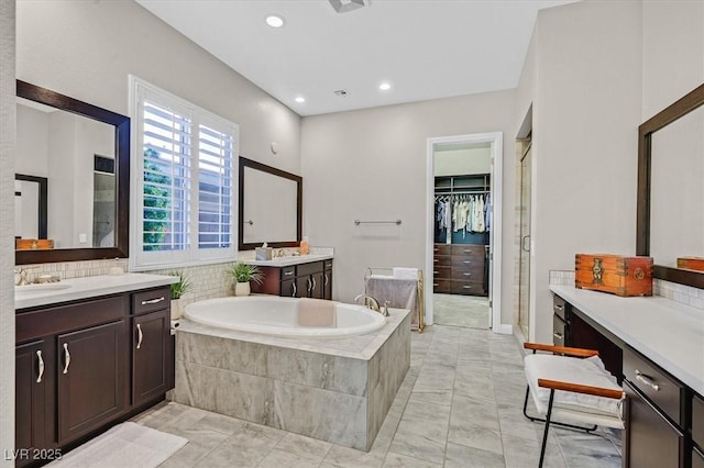 bathroom with tile patterned flooring, vanity, and independent shower and bath