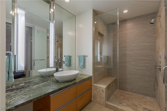 bathroom featuring tile patterned floors, vanity, and walk in shower