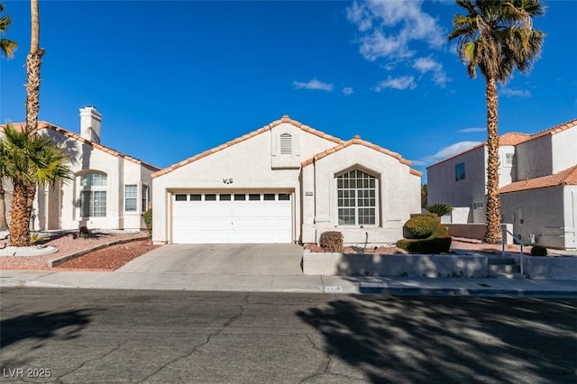 mediterranean / spanish house featuring a garage