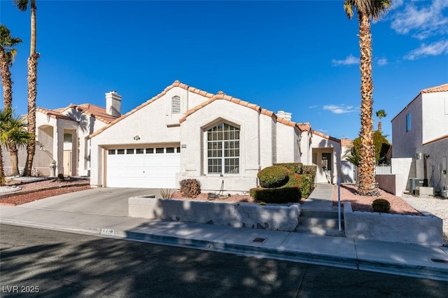 mediterranean / spanish-style house with a garage