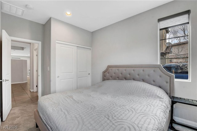 tiled bedroom with a closet