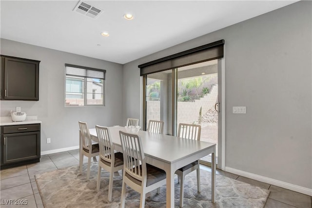 tiled dining room featuring a healthy amount of sunlight