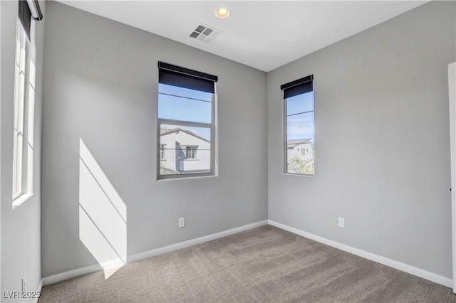 spare room featuring light colored carpet