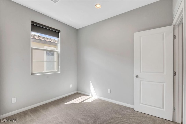 unfurnished room featuring light colored carpet