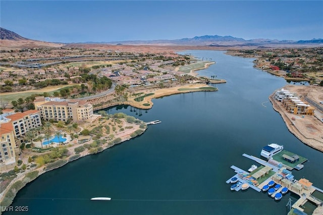 birds eye view of property with a water and mountain view