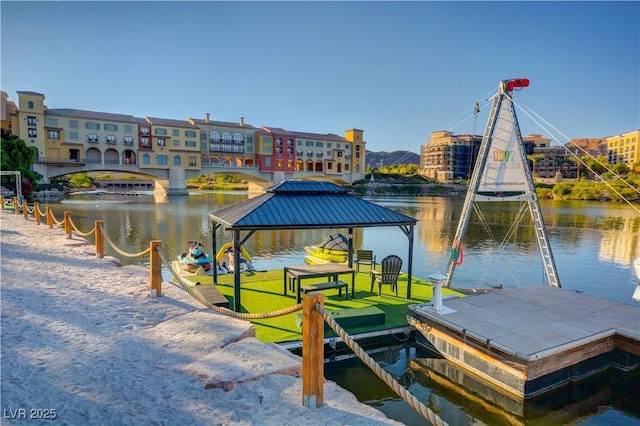 dock area featuring a gazebo, a yard, and a water view