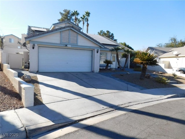 view of front of home with a garage and solar panels