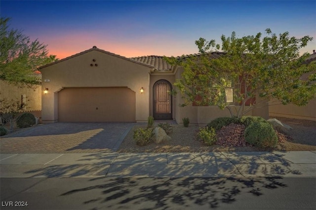 mediterranean / spanish-style home featuring a garage