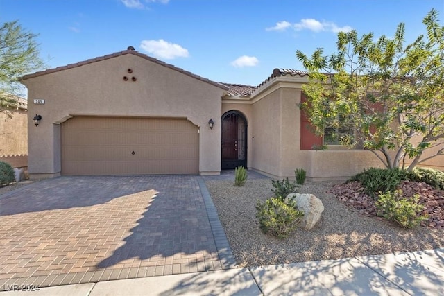 mediterranean / spanish home with a garage