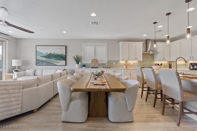 dining room with ceiling fan and sink