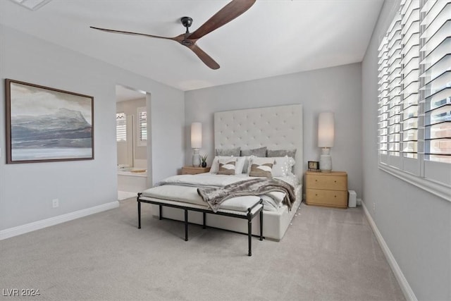 bedroom featuring ensuite bath, ceiling fan, and light carpet