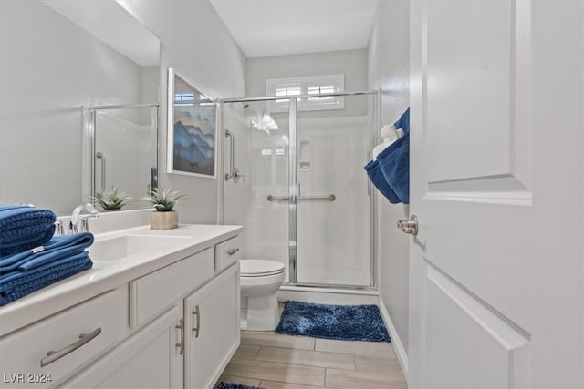 bathroom featuring vanity, toilet, and walk in shower