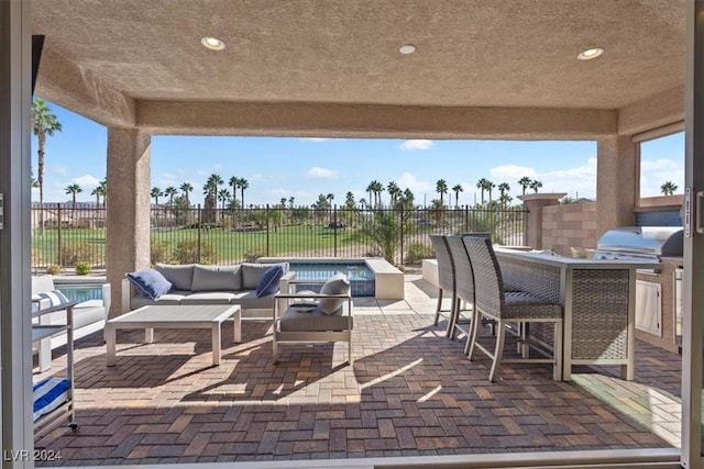 view of patio with an outdoor living space and a grill