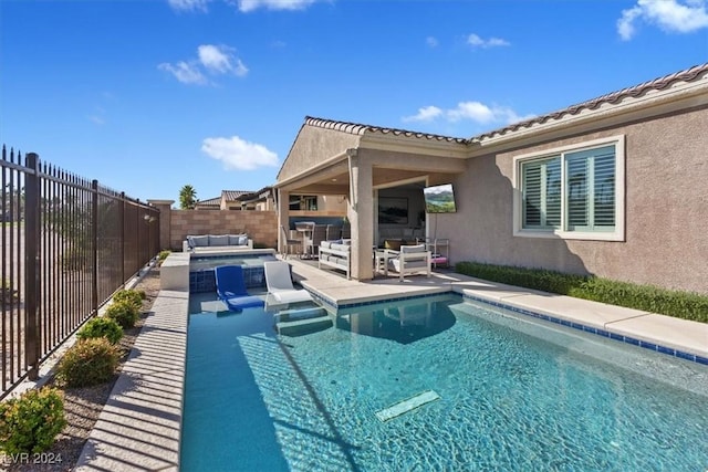 view of swimming pool with outdoor lounge area and a patio