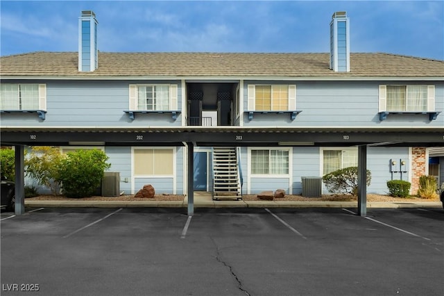 rear view of property featuring cooling unit