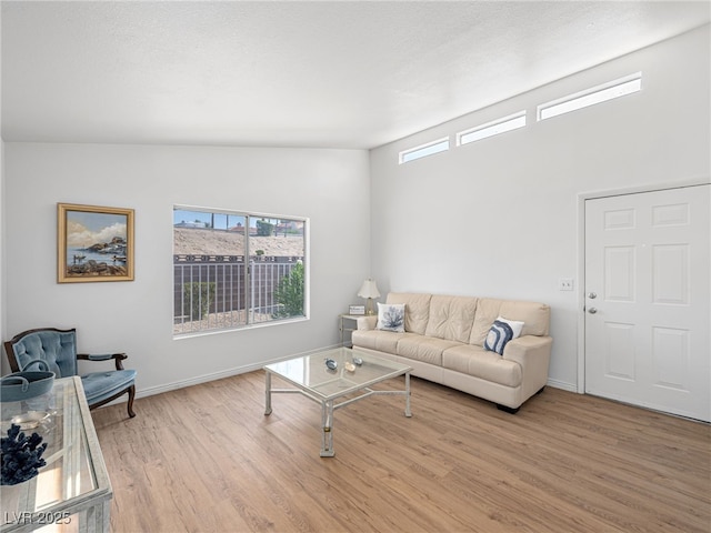 living room featuring a textured ceiling and light hardwood / wood-style flooring