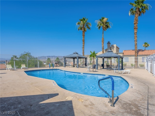 view of swimming pool featuring a gazebo, a mountain view, and a patio