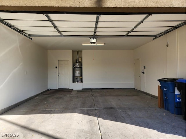 garage with secured water heater and a garage door opener