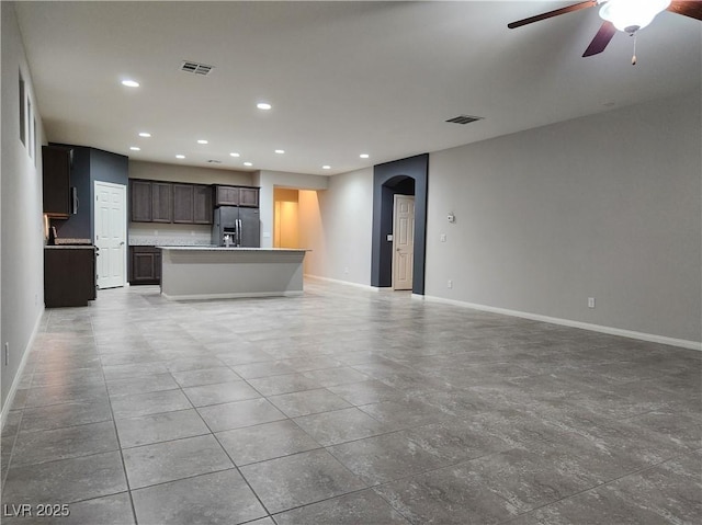 unfurnished living room with ceiling fan