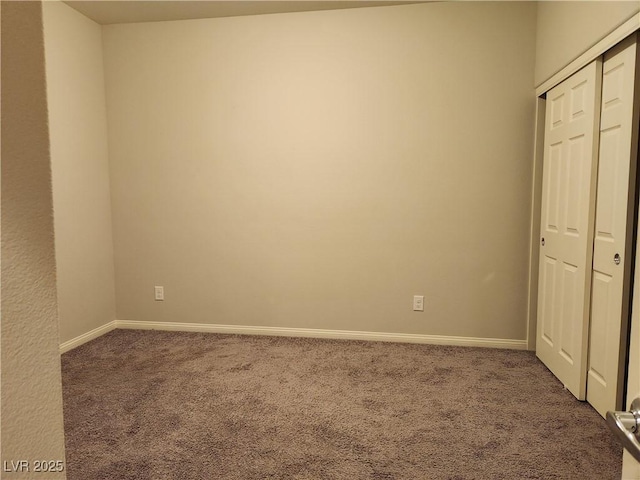 unfurnished bedroom featuring carpet floors and a closet