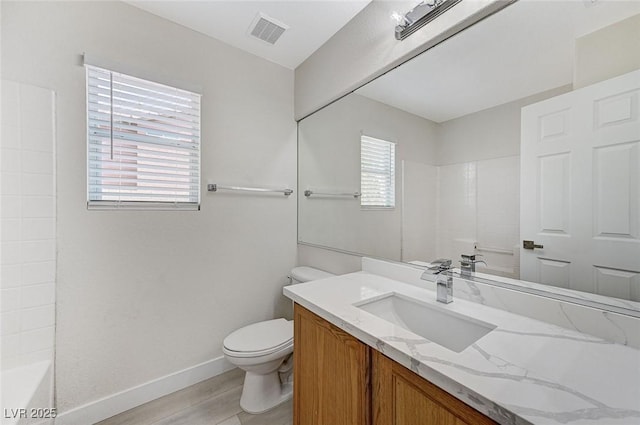 bathroom featuring hardwood / wood-style flooring, vanity, and toilet