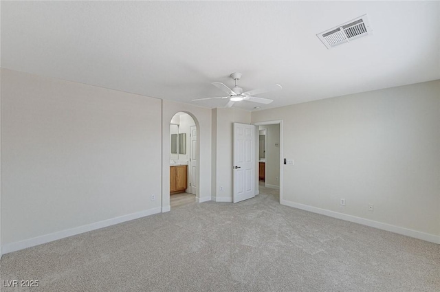 spare room featuring light carpet and ceiling fan